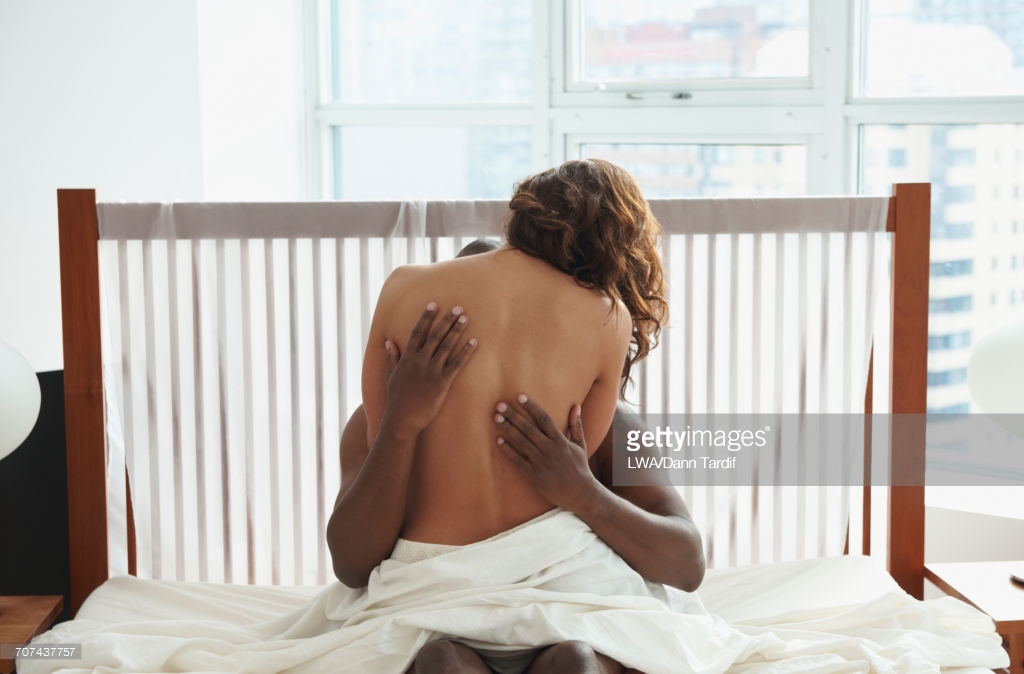 Woman and man hugging in bed